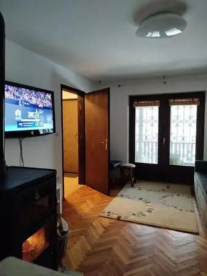 a living room with a flat screen tv on the wall at GOČ Planinska Kuća MILJA in Kraljevo