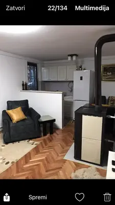 a living room with a couch and a stove at GOČ Planinska Kuća MILJA in Kraljevo