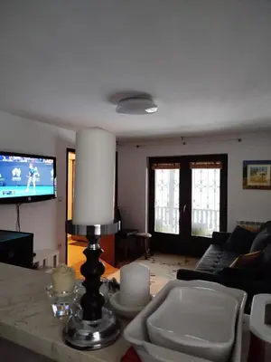 a living room with a couch and a table with a lamp at GOČ Planinska Kuća MILJA in Kraljevo