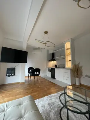 a living room with a couch and a table at Apartment in Vila dr Milovan in Vrnjačka Banja