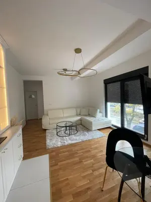 a living room with a couch and a table at Apartment in Vila dr Milovan in Vrnjačka Banja