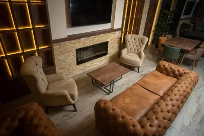 a living room with a couch and chairs and a fireplace at Hotel & Restaurant Ponte Bianco in Vranje