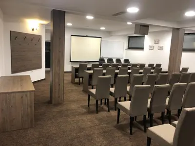 a conference room with chairs and a white screen at Hotel & Restaurant Ponte Bianco in Vranje