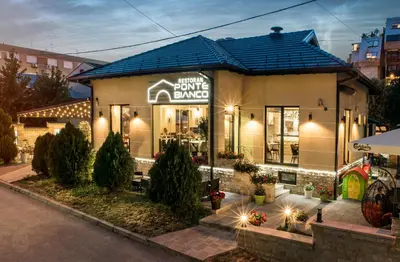 a store with a sign that reads home baked at Hotel & Restaurant Ponte Bianco in Vranje