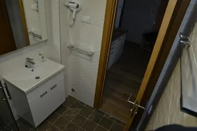 a bathroom with a sink and a shower at Kraljevi Cardaci Cardak in Kopaonik