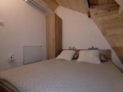 a bedroom with a bed with two pillows on it at A Bre Da Bre Family Club in Niš