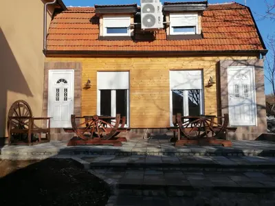 a group of benches in front of a house at A Bre Da Bre Family Club in Niš