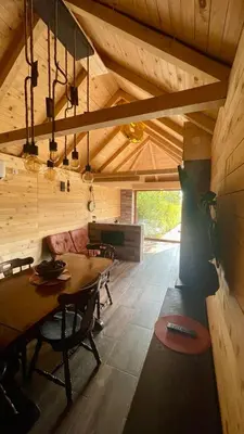 a dining room with a table and chairs in a house at A Bre Da Bre Family Club in Niš