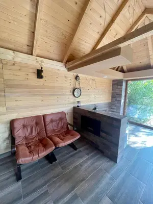 a living room with a couch in a wooden room at A Bre Da Bre Family Club in Niš