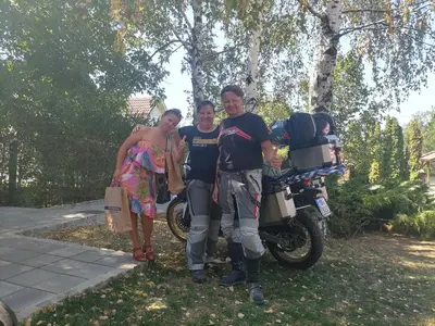 a group of three people standing next to a motorcycle at A Bre Da Bre Family Club in Niš