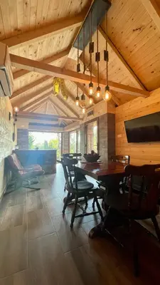 a dining room with a wooden ceiling and a table and chairs at A Bre Da Bre Family Club in Niš