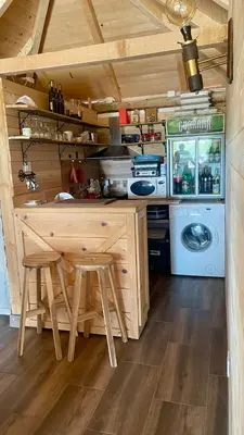 a kitchen with a table and a washing machine at A Bre Da Bre Family Club in Niš
