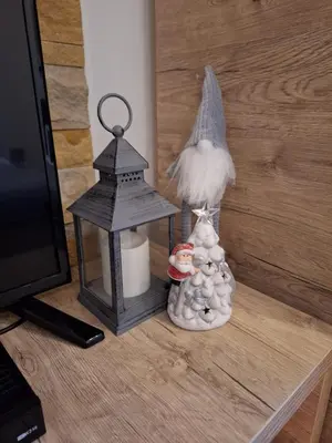 a group of figurines on a table next to a tv at Apartmani L6 & P90 Milmari Kopaonik in Kopaonik