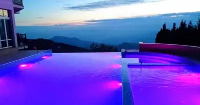 a swimming pool with pink lights on a house at Apartmani L6 & P90 Milmari Kopaonik in Kopaonik