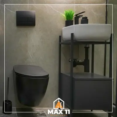 a bathroom with a sink and a toilet at MAX 11 Apartman in Kruševac