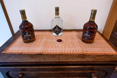 two bottles of alcohol sitting on top of a dresser at Vila Milica Apartmani in Kopaonik