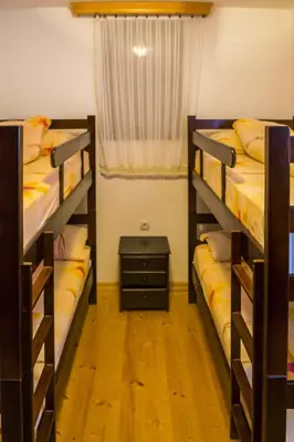 two bunk beds in a room with a window at Vila Milica Apartmani in Kopaonik