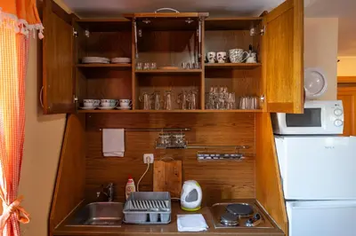 a small kitchen with a sink and a refrigerator at Vila Milica Apartmani in Kopaonik