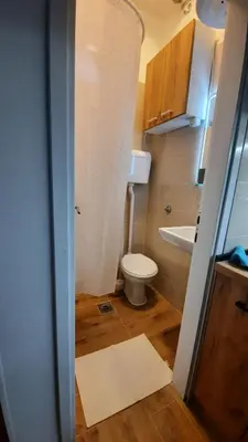 a small bathroom with a toilet and a sink at Apartman GreenPine in Soko Banja