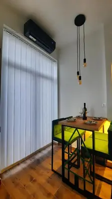 a living room with a table and a couch at Apartman GreenPine in Soko Banja
