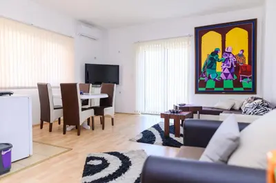 a living room with a couch and a dining room at Apartmani Merlin in Soko Banja