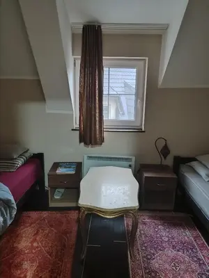 a room with two beds and a window at WEGA Star Apartmani in Brzeće
