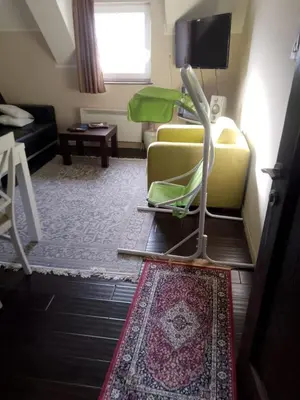 a living room with a yellow couch and a tv at WEGA Star Apartmani in Brzeće