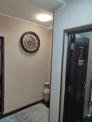 a clock on a wall next to a door at WEGA Star Apartmani in Brzeće