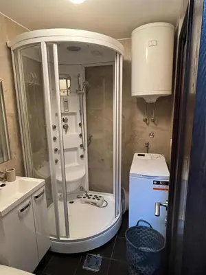 a small bathroom with a shower and a sink at WEGA Star Apartmani in Brzeće
