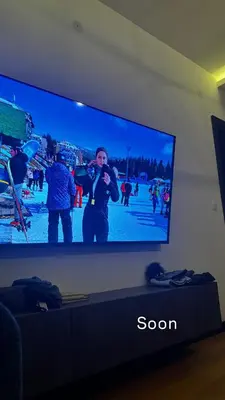a television screen with a man taking a picture on it at Glecer A07 in Kopaonik