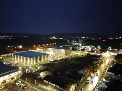 a city at night with cars parked in a parking lot at Studio apartman Nataly in Kruševac