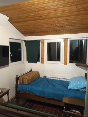 a bedroom with a bed in a room with windows at KopanikSkiRooms15E in Kopaonik
