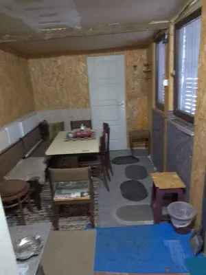 a living room with a table and a dining room at KopanikSkiRooms15E in Kopaonik