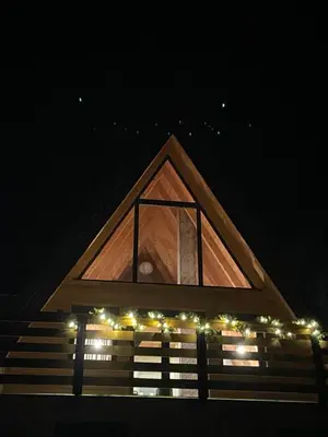 a building with a window with christmas lights on it at KoCHALET Apartment in Crni Vrh