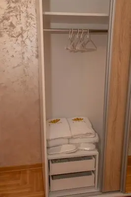a closet with a pile of towels in it at Lotos Apartments in Kruševac
