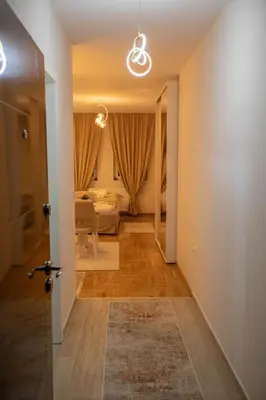 a hallway with a living room and a bedroom at Lotos Apartments in Kruševac