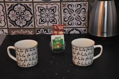 two coffee mugs sitting on top of a table at BeLux apartment in Niš