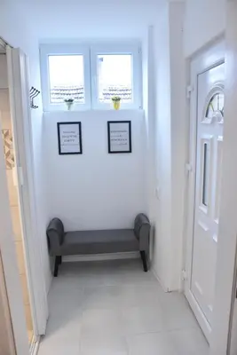 a hallway with a bench next to a door at BeLux apartment in Niš