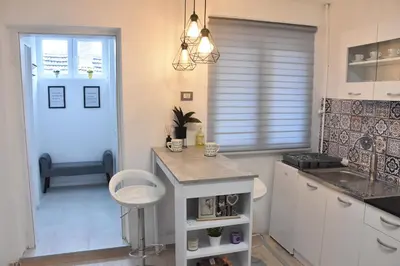 a kitchen with a island in the middle of a room at BeLux apartment in Niš