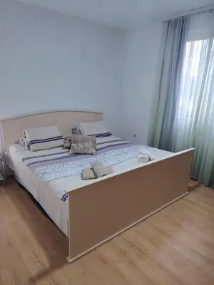 a large bed with two towels on it in a bedroom at Fili 1 in Ćuprija