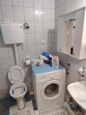 a small bathroom with a toilet and a sink at Fili 1 in Ćuprija