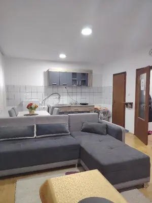 a living room with a couch and a kitchen at Fili 1 in Ćuprija