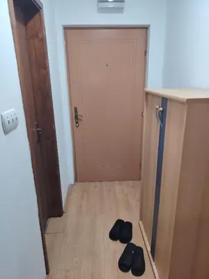 a pair of shoes sitting on the floor in front of a door at Fili 1 in Ćuprija
