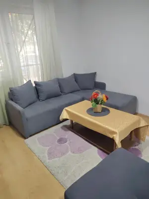 a living room with a blue couch and a coffee table at Fili 1 in Ćuprija