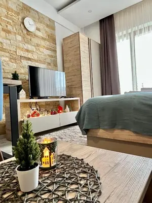 a bedroom with a christmas tree on a coffee table at ICE-KOP Milmari in Kopaonik