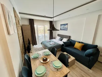 a living room with a table and a couch at ICE-KOP Milmari in Kopaonik