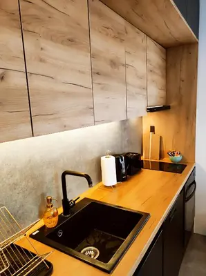 a kitchen with a sink and a wooden counter top at Riverside LUX Apartment in Pirot