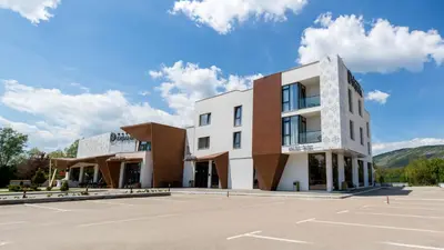 an empty parking lot in front of a building at Hotel Dijana in Pirot