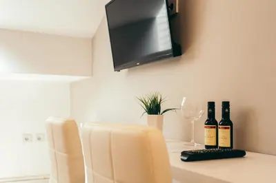 two bottles of wine sitting on a table with a glass at Hotel Dijana in Pirot