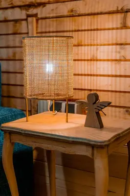a table with a lamp on top of it at Viktorija chalet in Kopaonik
